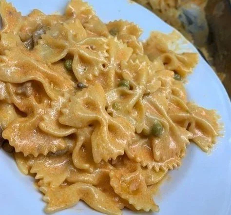 Dish of Farfalle alla Boscaiola with mushrooms and sausage