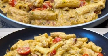 Pasta con Melanzane e Pomodorini servita in un piatto ricco di sapori mediterranei.