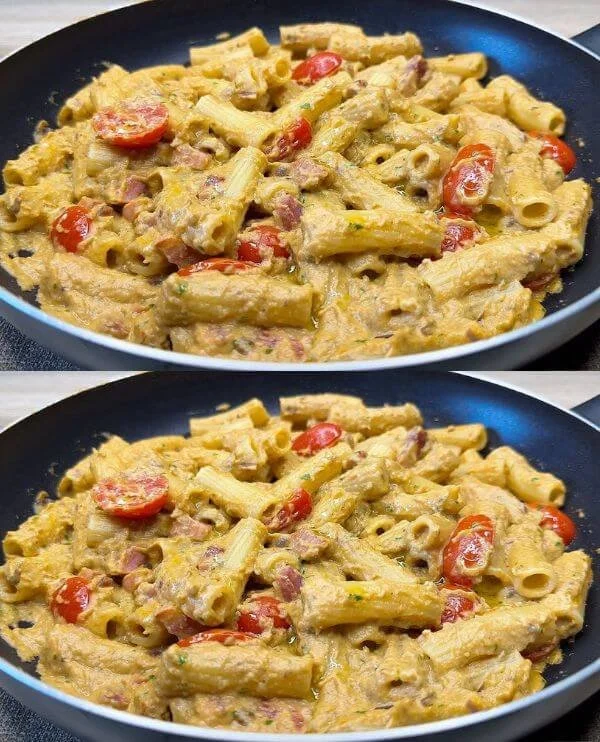 Pasta con Melanzane e Pomodorini servita in un piatto ricco di sapori mediterranei.